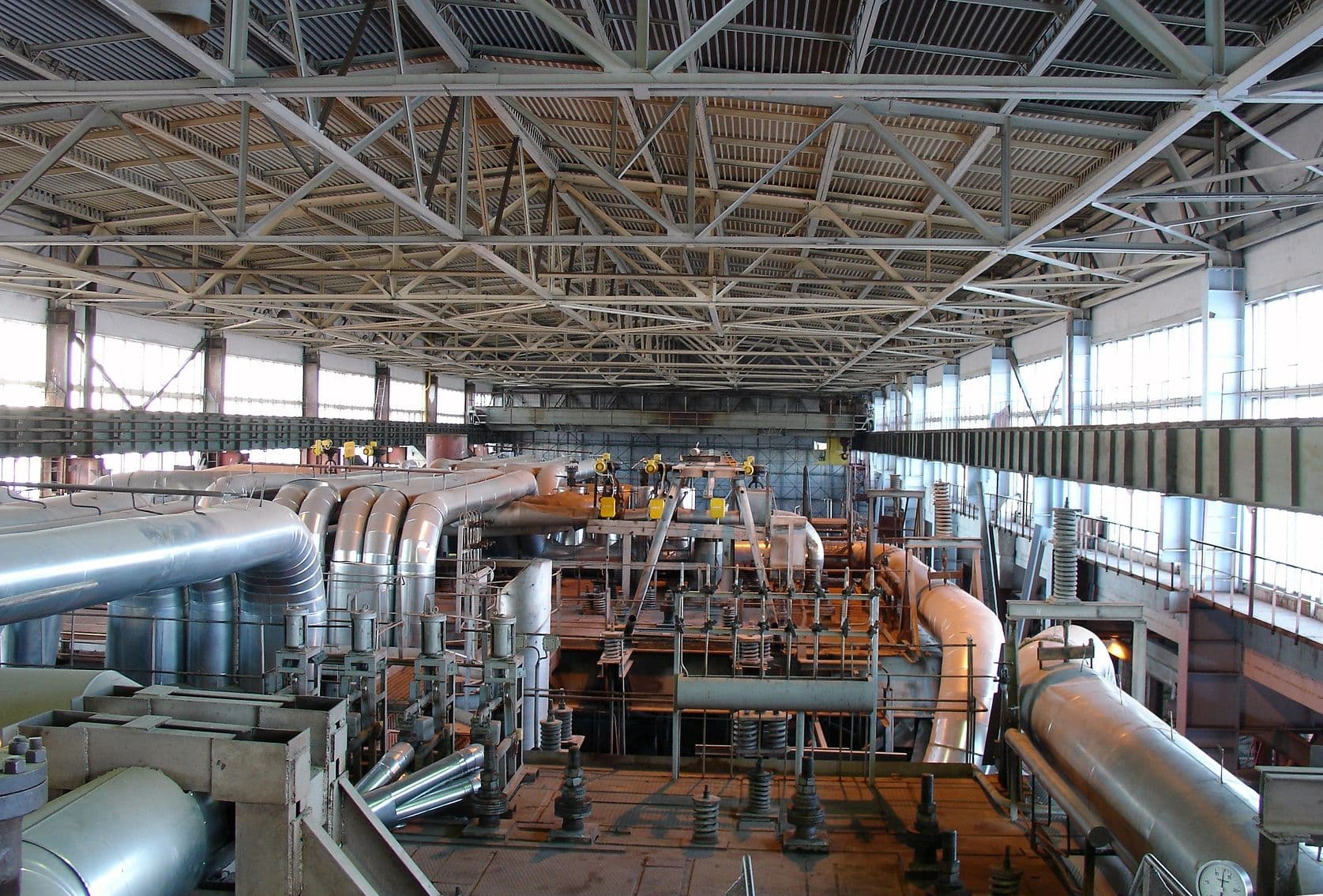 Wide industrial interior with mechanical piping and equipment