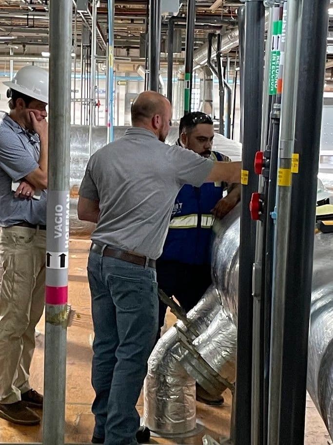 People examining pipework in an industrial installation